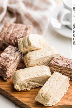 Halva. Sweet oriental dessert on cutting board. 131988035