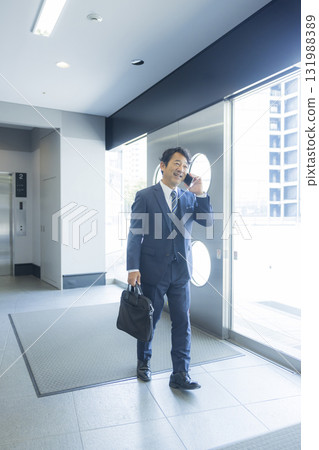 Businessman walking in an office building Businessman walking in an office building 131988389