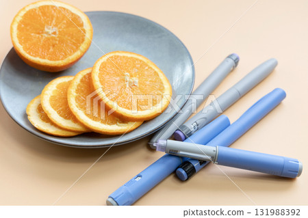 Insulin injection pen for diabetics and weight loss and plate with orange 131988392