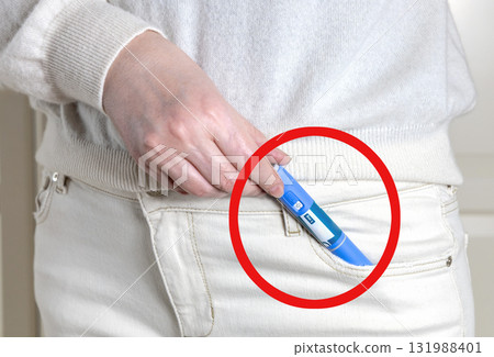 Woman in white clothes with Ozempic insulin pen in her pants pocket with a red circle stroke Woman in white clothes with Ozempic insulin pen in her pants pocket with a red circle stroke 131988401