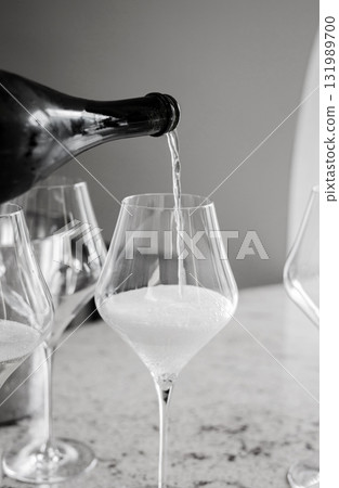 champagne being poured into a glass champagne being poured into a glass 131989700
