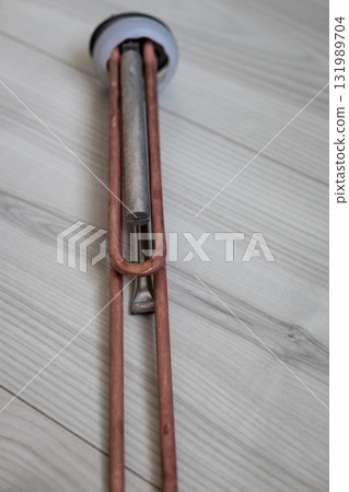 Clean heating element of an electric hot water boiler 131989704