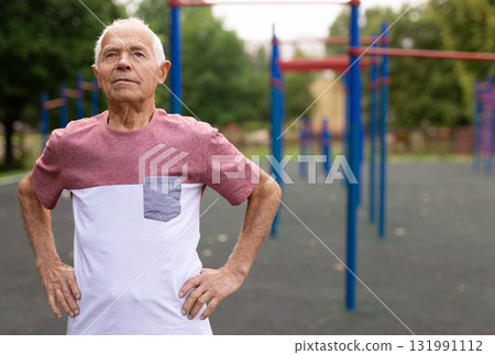 Portrait of sporty grandfather on playground in summer park 131991112