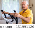 Male is working out on elliptical machine for elder healthy concept 131991120