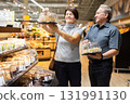 husband and wife choose cake in store for festive dinner 131991130