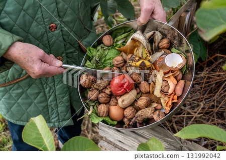 Kitchen waste deposit for compost in the garden 131992042