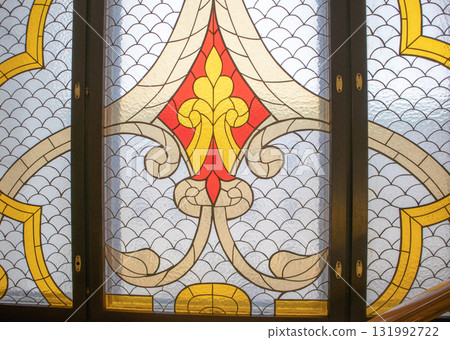 Stained glass window with gothic pattern and golden accents 131992722