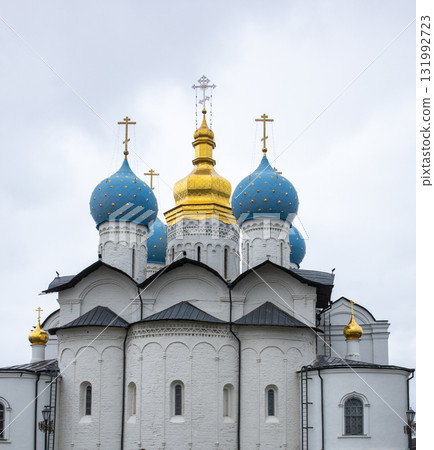 Orthodox church domes with gold and blue under cloudy sky 131992723