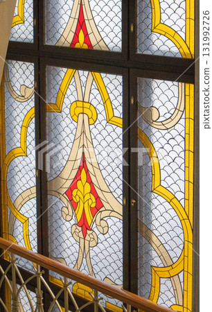Stained glass window with gothic pattern and golden accents 131992726