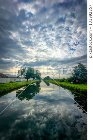 A Serene Reflection on a Beautiful Waterway Beneath Dramatic and Captivating Skies A Serene Reflection on a Beautiful Waterway Beneath Dramatic and Captivating Skies 131992857