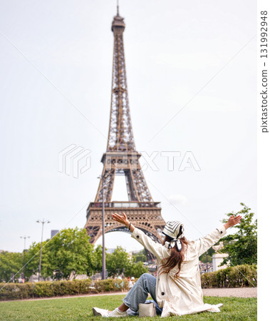 Happy woman celebrating near Eiffel Tower in Paris Happy woman celebrating near Eiffel Tower in Paris 131992948