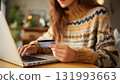 A focused woman enters credit card details on a laptop for secure online payment, symbolizing fast e-commerce and convenient digital banking. AI Generated 131993663