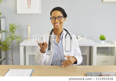 Portrait Of Positive Doctor On Video Call Portrait Of Positive Doctor On Video Call 131993836