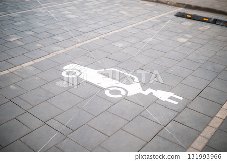 Electric recharging point for electric cars, EVs that pollute less, painted on the ground. 131993966