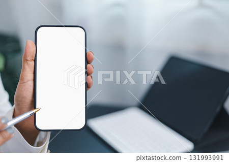 Hand holding smartphone with blank white screen, mobile app mockup and digital technology concept 131993991