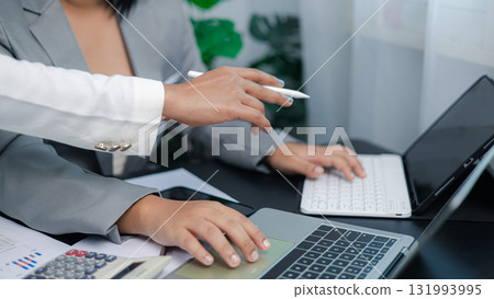 Business team collaborating and discussing project on laptop and tablet, teamwork and digital strategy concept Business team collaborating and discussing project on laptop and tablet, teamwork and digital strategy concept 131993995