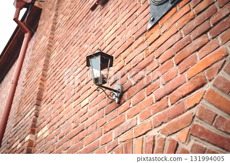 Street lamp on the wall of a brick building Street lamp on the wall of a brick building 131994005