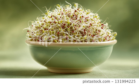 Fresh sprouts in a bowl on a green backdrop for healthy eating 131994225