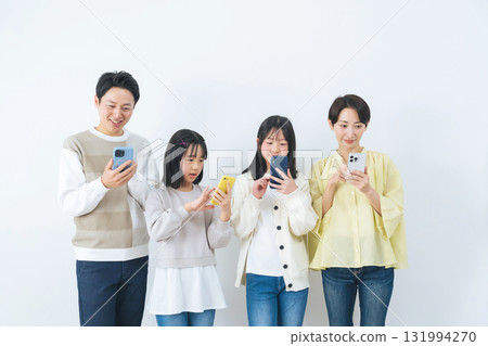 Girl family using smartphone with smile Girl family using smartphone with smile 131994270