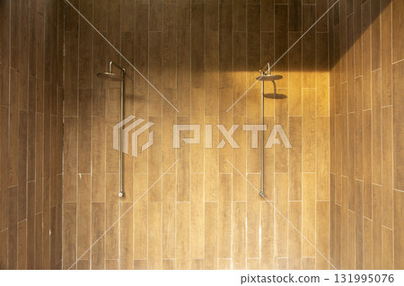 Outdoor shower by the swimming pool. Refreshing poolside cleansing on a sunny day. Luxury vacation and relaxing resort lifestyle. Outdoor shower by the swimming pool. Refreshing poolside cleansing on a sunny day. Luxury vacation and relaxing resort lifestyle. 131995076