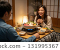 A woman and her husband enjoy a hot pot together in a Japanese-style kotatsu 131995367