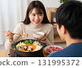 A smiling woman with medium hair enjoying hotpot with her husband 131995372