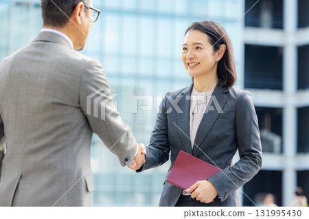 Handshake men and women in suits 131995430
