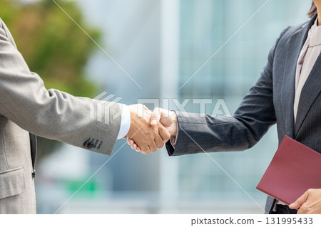 Handshake men and women in suits Handshake men and women in suits 131995433