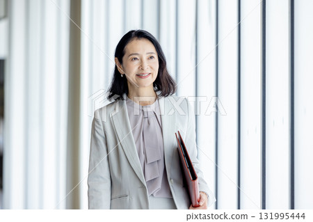Businesswoman walking in the office 131995444