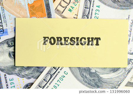 FORESIGHT text written on yellow paper on the background of banknotes. Planning and analytics concept. FORESIGHT text written on yellow paper on the background of banknotes. Planning and analytics concept. 131996060