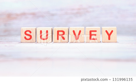 Wooden blocks, each displaying a red letter, spell out SURVEY. The blocks sit neatly aligned on a textured white surface, inviting participation and input Wooden blocks, each displaying a red letter, spell out SURVEY. The blocks sit neatly aligned on a textured white surface, inviting participation and input 131996135