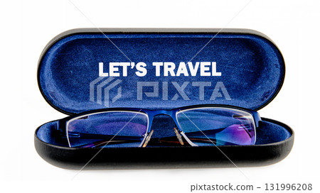 Eyeglasses rest inside an open, lined case. The case has LET IS TRAVEL printed inside. It evokes the anticipation of seeing new sights on an upcoming trip 131996208