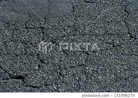 Close-up of cracked asphalt. Urban background material 131996270