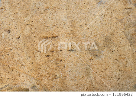 Close-up of brown stone with uneven surface. Stone or rock texture Close-up of brown stone with uneven surface. Stone or rock texture 131996422