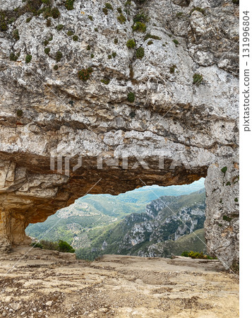 view of La Foradada rock arch in Serra del Montsia 131996804