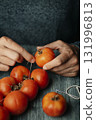 a man threading Spanish tomates de colgar 131996813