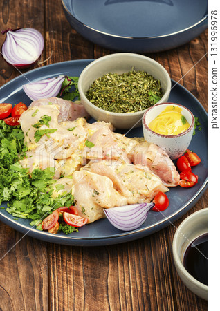 Raw chicken medallions. 131996978