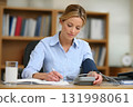professional woman at office desk using blood pressure monitor lifestyle health scene 131998061