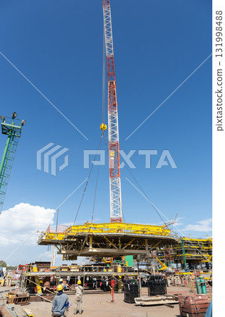 Heavy crane in oil rig construction work. 131998488