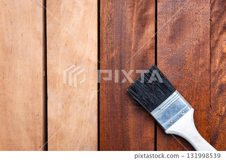 Paint brush and wood material in construction work. Paint brush and wood material in construction work. 131998539
