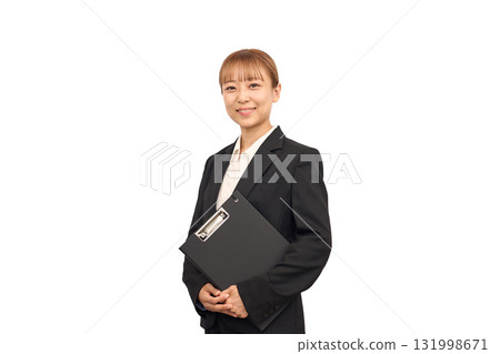 A woman in a business suit holding documents A woman in a business suit holding documents 131998671
