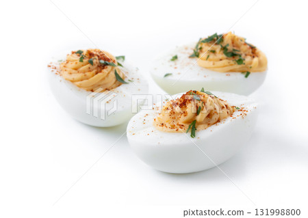 Homemade hard Boiled Deviled Eggs garnished with herbs 131998800