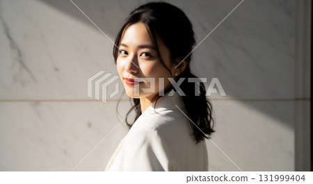 Woman in a white jacket, natural outdoor portrait 131999404