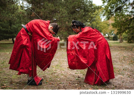 Multicultural wedding couple bowing in traditional Chinese ceremony Multicultural wedding couple bowing in traditional Chinese ceremony 131999630