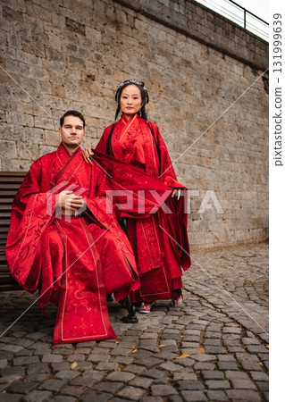 Multicultural wedding couple posing in traditional Chinese hanfu clothing 131999639
