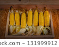 Yellow Corn Ears Arranged in Wooden Basket 131999912