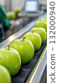 Green apples with water drops moving on production line in food industry 132000940