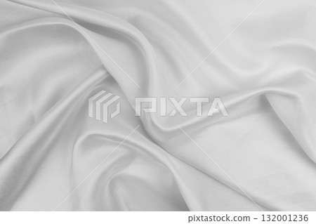 White fabric flowing smoothly on a surface 132001236