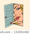 A woman looks through an open door. Announcing a new offer for buyers. Surveillance of personal data on the Internet. 132001482