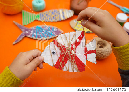 creative fish made of cardboard materials, thread and paint, step-by-step instructions, orange background 132001570